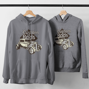 Custom grey hoodies with vintage car design hanging on rack.